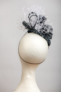 Dark navy and white headpiece with waffle veiling.