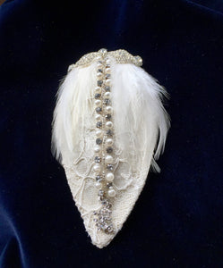 Diamante and ivory feather bridal headpiece.