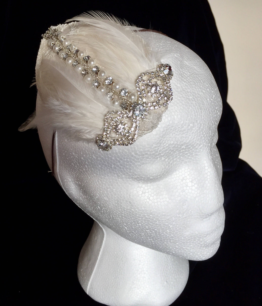 Diamante and ivory feather bridal headpiece.