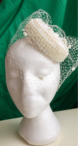Bridal pillbox hat with pearl detail.