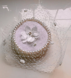 Bridal pillbox hat with pearl detail.