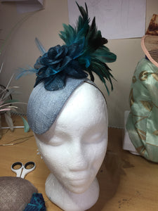 Teal and blue flower and feather headpiece.