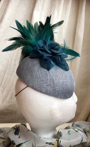 Teal and blue flower and feather headpiece.