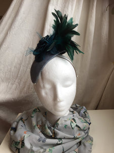 Teal and blue flower and feather headpiece.