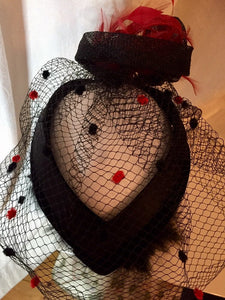 Black and red diamond headpiece with birdcage.